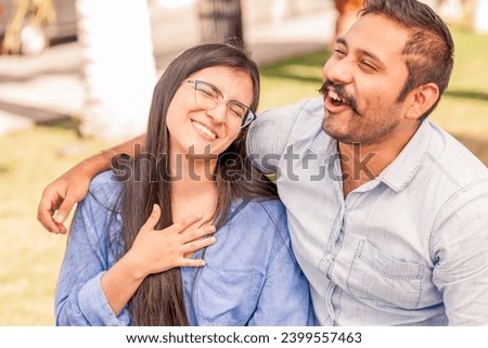 Boyfriends are sitting on a bank of a public park Royalty-Free Stock Photo #2399557463