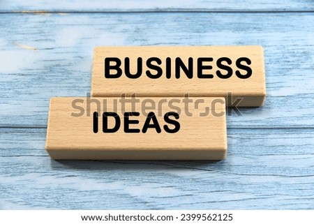 "BUSINESS IDEAS" text or message short word english letter on wooden cubes block with blue vintage background.Copy space.