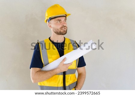 Portrait of smart and good looking caucasian white male foreman or construction contractor smiles to camera and looks away. Close up shot of construction engineer - foreman with copyspace.