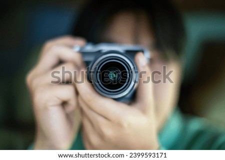photographer take pictures Snapshot with camera. man hand holding with camera looking through lens.Concept for photographing articles Professionally