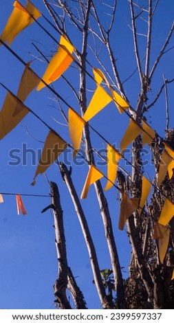 A closeup of yellow flags or banners for a fiesta or festival.