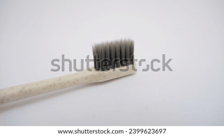 Close up toothbrush on white background. Gray toothbrush bristles. Selective focus. Teeth care concept.