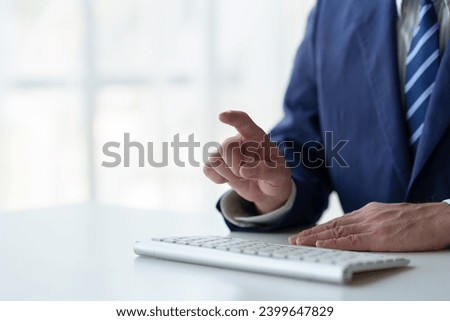 Businessman working using laptop computer at table in office typing on computer keyboard Email or communicate online and point at the screen for a clear target. 