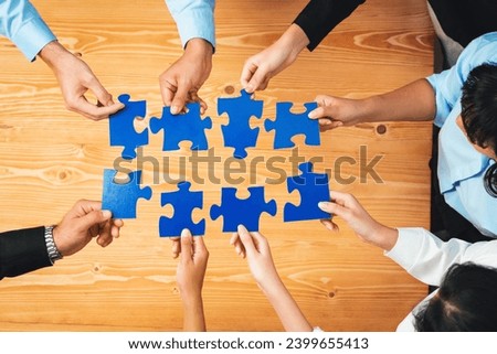 Top view multiethnic business people holding jigsaw pieces and merge them together as effective solution solving teamwork, shared vision and common goal combining diverse talent. Habiliment Royalty-Free Stock Photo #2399655413