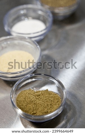 Close Up of Powdered Spices, Cooking Ingredients in Glass Bowls on Stainless Steel Background