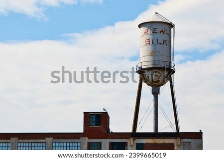 Vintage Real Silk Water Tower Over Industrial Brick Building in Indianapolis