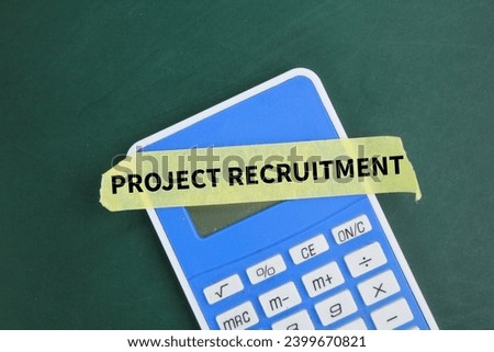 a calculator and a sticker with the word project recruitment. business project concept Royalty-Free Stock Photo #2399670821