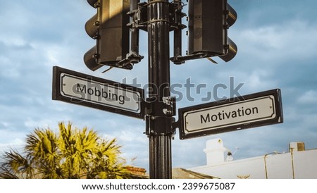 An image with a signpost pointing in two different directions in German. One direction points to motivation, the other points to bullying.