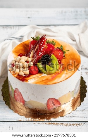 Fruitcake. Birthday cake with fresh fruit on a white background. Close up