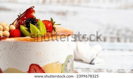 Fruitcake. Birthday cake with fresh fruit on a white background. Copy space. Empty space for text