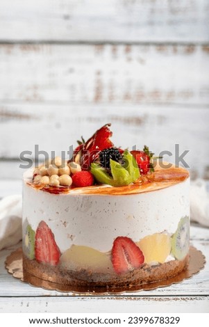 Fruitcake. Birthday cake with fresh fruit on a white background