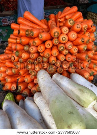 A pile of carrots for sale at a traditional market