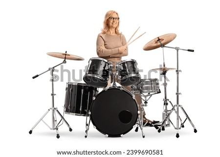 Mature female drummer with a drum set isolated on white background