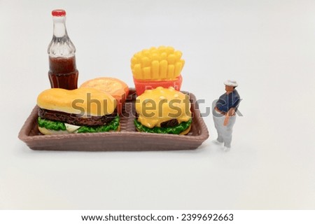 miniature figurine of an obese man with fast-food tray
