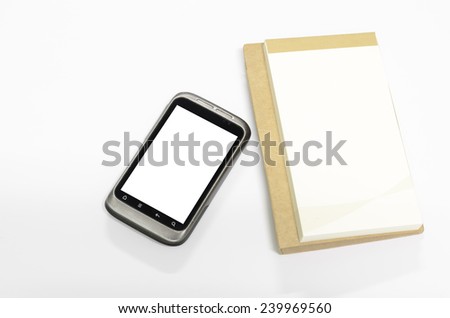 used smart phone with note book on a white background