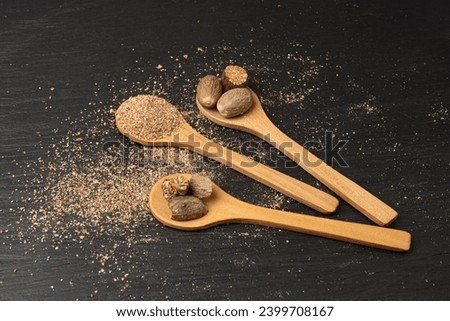 Nutmeg in Black Plate, Myristica Fragrans Fruit, Dry Spicy Nutmeg, Grated Whole Muscat Nut, Nut Meg Seasoning, Fragrans Nutty Spices Closeup Royalty-Free Stock Photo #2399708167