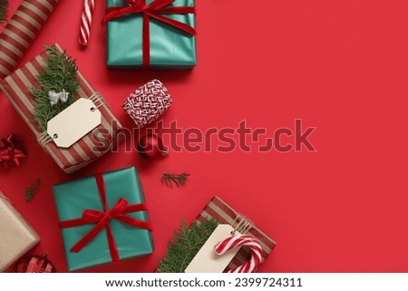 Composition with beautiful Christmas gifts on red background