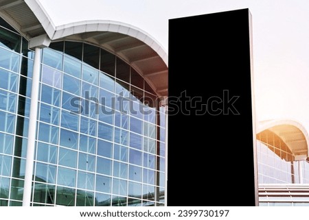 A Mockup of a Blank Sign in Front of a Modern Office Building in Hamburg. A Concept for a Business Branding and Signage in Europe.