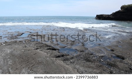 
beach view on a sunny day. coral rocks in the sea. beautiful crashing waves. the blue of the ocean.