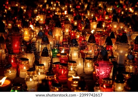 A sea of colorful candles light up the night in this beautiful image. A multitude of candles in various colors and sizes create a warm glow in this image.