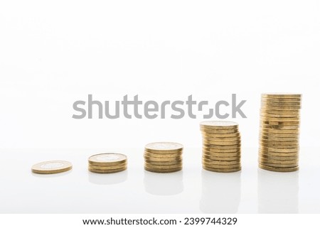 Photo of Coins stacked on white backgroud with smooth reflection. Concept of grow, investment, saving money.