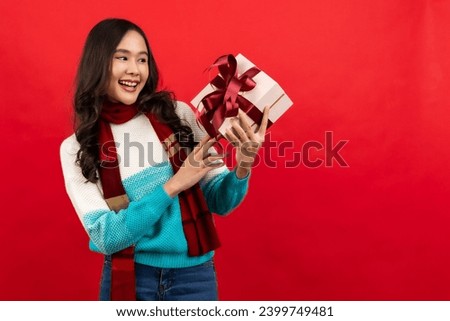 

Happy smiling asian woman holding gift box over red 

Happy smiling asian woman holding gift box over red background.

