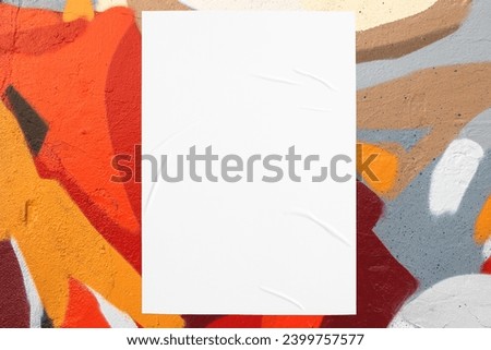 Closeup of colorful orange red beige gray painted urban wall texture with wrinkled glued poster template. Modern mockup for design presentation. Creative urban city background. 