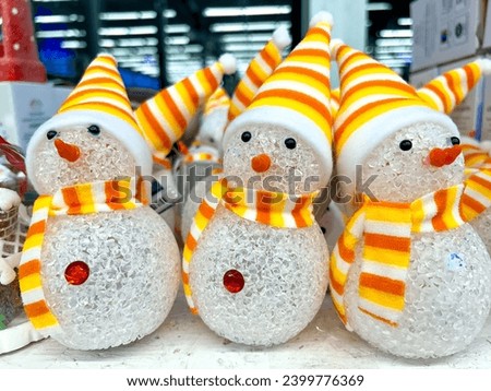 Snowman figurines on a store shelf. Symbol of the year 2024. Green dragon according to the horoscope. Kids toys