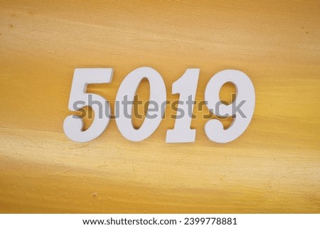 The golden yellow painted wood panel for the background, number 5019, is made from white painted wood.