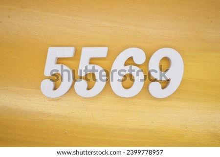 The golden yellow painted wood panel for the background, number 5569, is made from white painted wood.