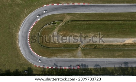 Aerial top view of Circuit motor racing track, Track for auto racing top view, Car race asphalt and curve grand prix street circuit, Aerial view asphalt race track. Royalty-Free Stock Photo #2399783723