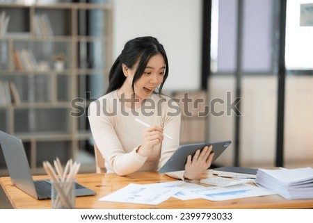 Asia businesswoman working on digital tablet executives meeting in an office using laptop...