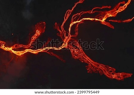 Rivers of Fire" captures the mesmerizing spectacle of volcanic lava flow, a relentless stream of molten energy that paints an awe-inspiring picture of nature's raw power and fiery beauty.