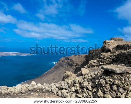 View of the small volcanic island of La Graciosa in the Atlantic Ocean. La Graciosa composed of volcanic rocks and sands. Lanzarote, Spain.