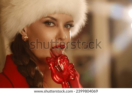 Woman with big braid in retro dress and jacket  in typical flat of Soviet Union times. Girl in white puffy fur hat celebrate New Year near New Year Tree. Portrait of beautiful woman with big red lips 