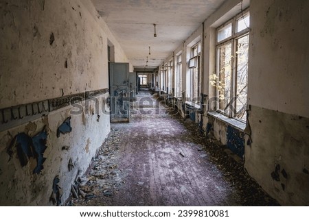 Corridor in school in Illinci abandoned village in Chernobyl Exclusion Zone, Ukraine Royalty-Free Stock Photo #2399810081
