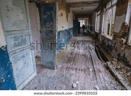 Corridor in school in Illinci abandoned village in Chernobyl Exclusion Zone, Ukraine Royalty-Free Stock Photo #2399810103