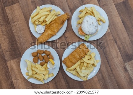 Chip Shop Food, deep fried food, battered food, fish and chips, black pudding, white pudding, burgers and chips, pies, chips, fish chips and peas Royalty-Free Stock Photo #2399821577