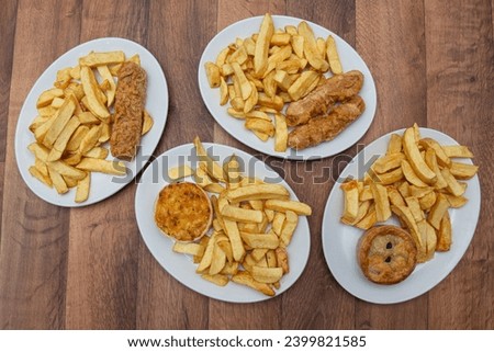 Chip Shop Food, deep fried food, battered food, fish and chips, black pudding, white pudding, burgers and chips, pies, chips, fish chips and peas Royalty-Free Stock Photo #2399821585