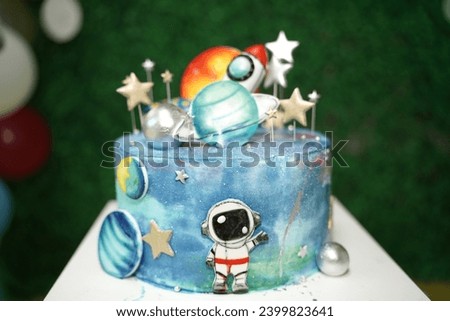  Birthday cake, space shuttle theme. On the white table. Stars. Balloons. Green grass concept. Background.                            