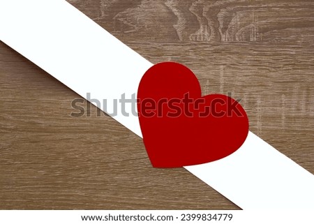 red heart sign, symbol with white paper ribbon isolated on wooden table background. mock up, empty copy space for inscription. 14th february happy Valentines day holiday, event. mockup, template.
