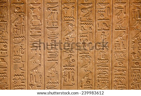 Egyptian hieroglyphs on the wall Royalty-Free Stock Photo #239983612