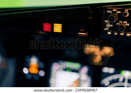 close-up of the cockpit of a passenger plane with many buttons on the control panel of airplane flight simulator Royalty-Free Stock Photo #2399838987