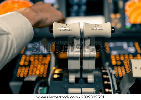 thrust lever in the cockpit of an airplane a close-up view of flight on an aircraft simulator Royalty-Free Stock Photo #2399839531