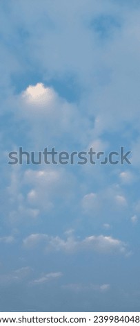 Cloudy Sky background. Small clouds covered the entire blue sky. White clouds covered the whole sky. Nature concept background. Vertical photo