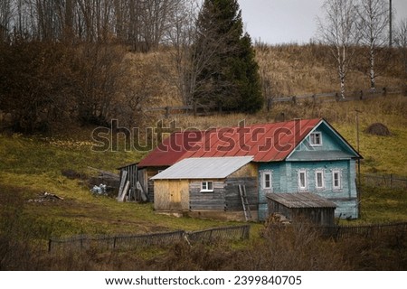 Old wooden house in the village on a autumn day, horizontal picture