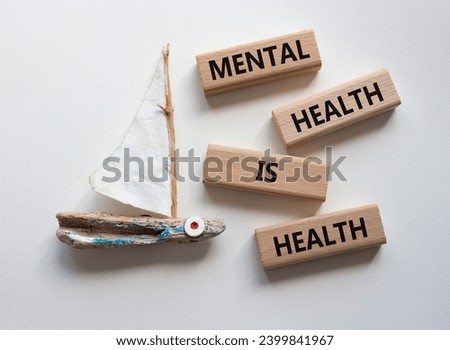 Mental Health symbol. Wooden blocks with words Mental Health is Health. Beautiful white background with boat. Medical and Health concept. Copy space.