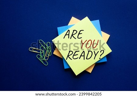 Are you ready symbol. Concept word Are you ready on yellow steaky note. Beautiful deep blue background. Business and Are you ready concept. Copy space