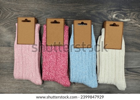 Four pairs of colored socks on a wooden background.