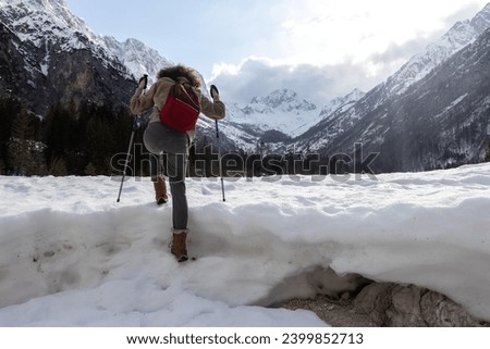 Gritty Adult Woman Conquering Adversities on Winter Hike in Mountains Snowy Wilderness Royalty-Free Stock Photo #2399852713